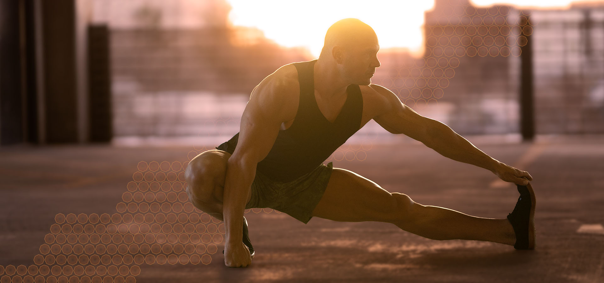 Joel Griffin, lead trainer with Titan Bodybuilding, stretching during the Golden Hour.