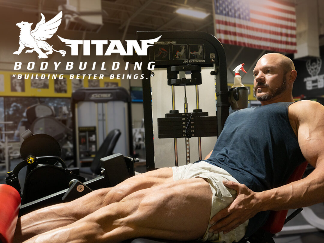 Joel Griffin, lead trainer and bodybuilding coach, doing some leg extensions on leg day.